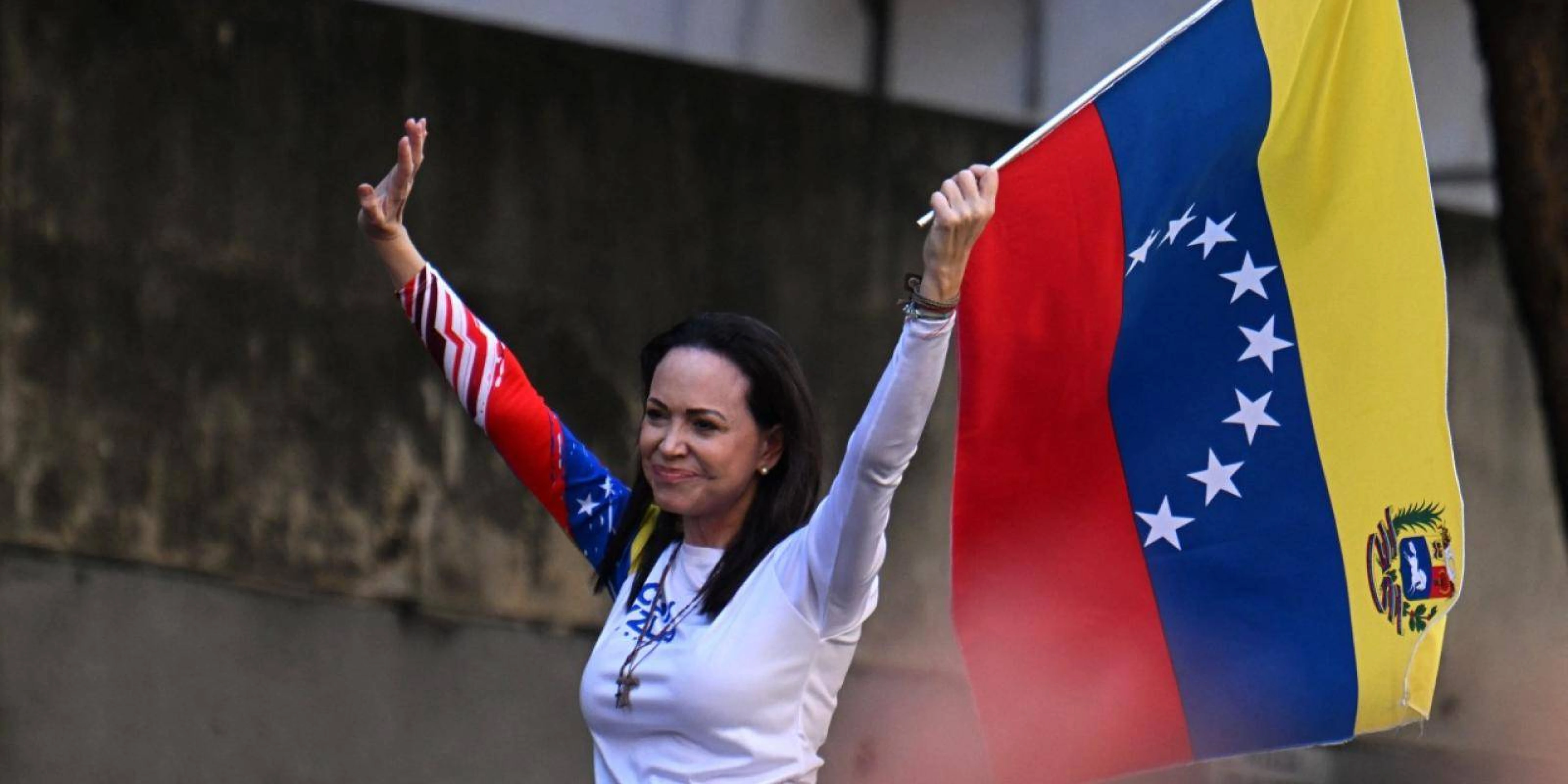 Venezuelan opposition leader Maria Corina Machado waves a national flag during an opposition protest in Caracas. (Photo by JUAN BARRETO/AFP via Getty Images