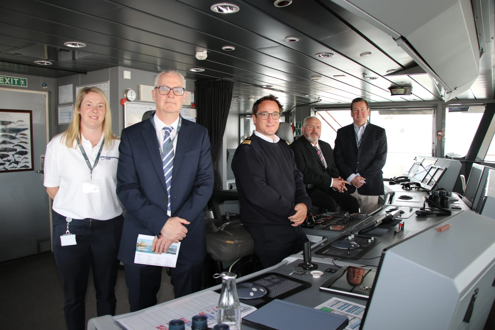 A line-up of cruise delegates pictured inside the ship's navigation bridge.
